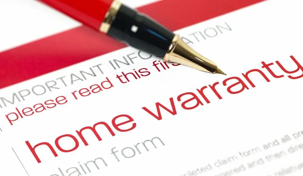 Claim form document that says home warranty with a pen 